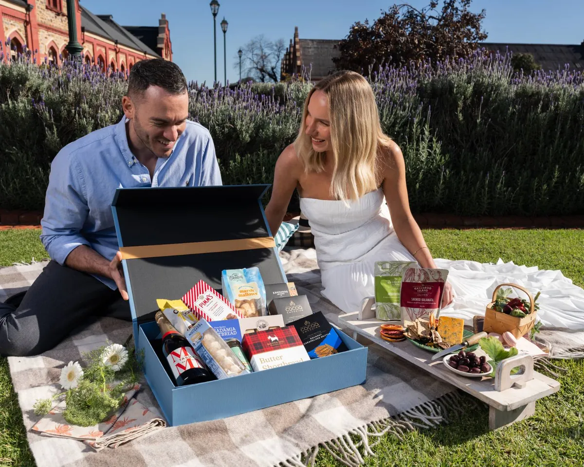 A luxury Gourmet Pantry hamper opened by candlelight