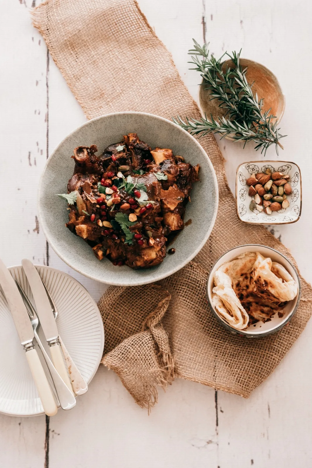 Moroccan style lamb tagine with pomegranate, coriander and almonds, served with warm flatbread