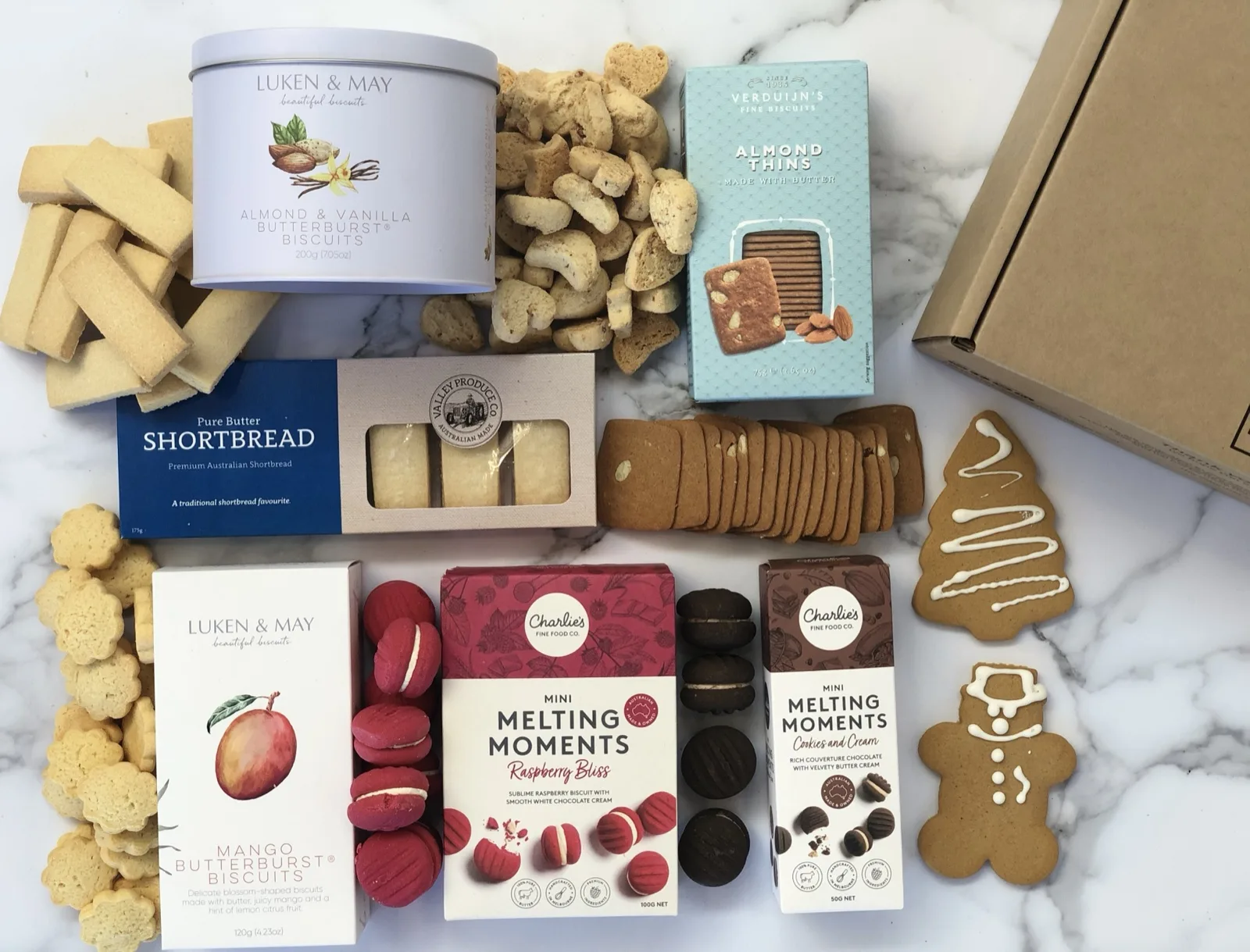 Shelf stable Christmas biscuits on a bench: butter shortbread, almond thins, melting moments and gingerbread