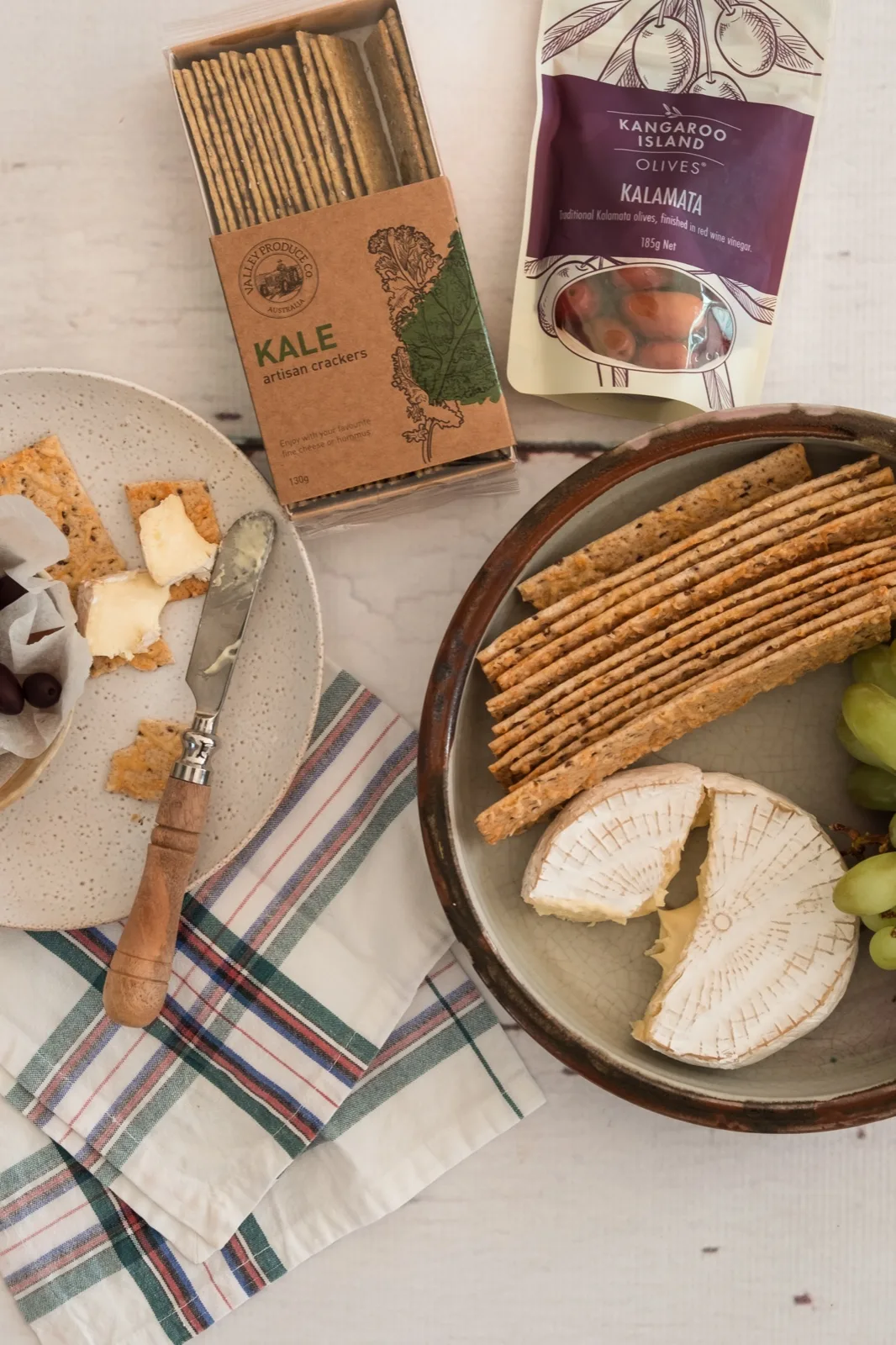 Valley Produce Co kale crackers, Kangaroo Island kalamata olives, brie and grapes laid out