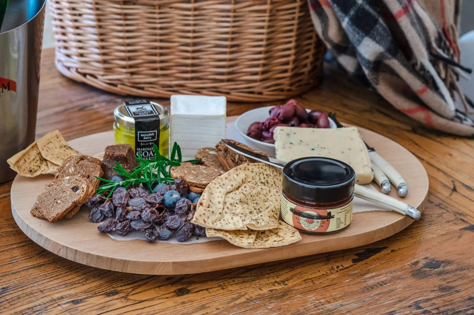 Antipasto board with kalamata olives, brie, truffle cheese, pita crisps, muscatels and a j