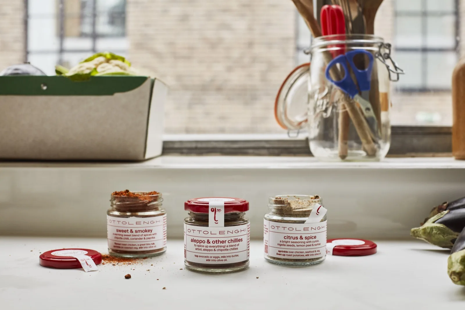 Ottolenghi sweet and smokey, aleppo and other chillies and citrus and spice jars open on a